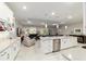 Bright open concept kitchen with a large central island, stainless appliances, and seamless flow to the living area at 10033 Sw 96Th St, Ocala, FL 34481