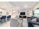 Bright and airy living room featuring a large TV, comfortable seating, and elegant décor at 10033 Sw 96Th St, Ocala, FL 34481