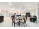 Open-concept living space with a kitchen island, dining table, and comfortable living area at 10033 Sw 96Th St, Ocala, FL 34481