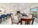 Open-concept living space with a kitchen island, dining table, and comfortable living area at 10033 Sw 96Th St, Ocala, FL 34481