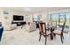 Inviting open living and dining area with comfortable seating and expansive windows at 10033 Sw 96Th St, Ocala, FL 34481