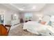 Spacious main bedroom with large windows, soft lighting, and neutral decor for a tranquil ambiance at 10033 Sw 96Th St, Ocala, FL 34481