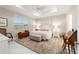 Comfortable main bedroom with tray ceiling, neutral decor, and soft carpet, creating a relaxing retreat at 10033 Sw 96Th St, Ocala, FL 34481