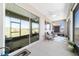 Covered lanai featuring comfortable seating, ceiling fan, and serene views of the green lawn at 10033 Sw 96Th St, Ocala, FL 34481