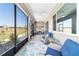 Relaxing covered lanai featuring furniture, ceiling fan, and scenic views of the community at 10033 Sw 96Th St, Ocala, FL 34481