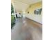 Covered back porch area with concrete flooring and exterior door at 10081 Sw 93Rd Ave, Ocala, FL 34481