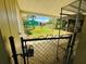 Gated chain link fence with view of a lawn at 10081 Sw 93Rd Ave, Ocala, FL 34481
