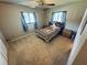 Bedroom featuring ceiling fan and windows providing natural light at 10081 Sw 93Rd Ave, Ocala, FL 34481