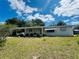 Well-kept single-story home featuring a covered carport and landscaped front yard, creating a charming and inviting exterior at 10081 Sw 93Rd Ave, Ocala, FL 34481