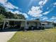 Classic single-story home with a covered carport and tidy front yard, providing a welcoming and practical living space at 10081 Sw 93Rd Ave, Ocala, FL 34481