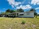Quaint single-story home with covered carport and manicured lawn, providing a cozy and appealing residential setting at 10081 Sw 93Rd Ave, Ocala, FL 34481