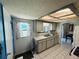 Functional kitchen area with double sink, white cabinets, tile flooring and natural light at 10081 Sw 93Rd Ave, Ocala, FL 34481