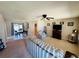 Inviting living room featuring neutral carpet, ceiling fan, and cozy furniture at 10081 Sw 93Rd Ave, Ocala, FL 34481