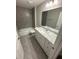 Bathroom featuring tiled walls, a shower and tub, and a vanity with storage underneath at 10785 Sw 130Th Ct, Dunnellon, FL 34432