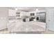 Modern kitchen with white cabinets, granite countertops, and stainless steel appliances at 10785 Sw 130Th Ct, Dunnellon, FL 34432