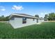 Expansive backyard featuring lush green grass, a view of the home's exterior, and serene surroundings at 10869 Sw 140Th Ave, Dunnellon, FL 34432
