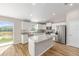 Modern kitchen featuring an island, sleek appliances, and lots of natural light from the sliding glass door at 10869 Sw 140Th Ave, Dunnellon, FL 34432