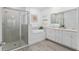 Stylish bathroom featuring a glass-enclosed shower, double vanity, and a soaking tub for a spa-like experience at 1119 Se 42Nd Rd, Ocala, FL 34480