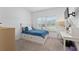 Bright bedroom with a twin bed, desk, and a window with blinds at 1119 Se 42Nd Rd, Ocala, FL 34480