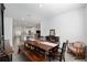 Open-concept dining area with a wooden table and bench, adjacent to the kitchen, ideal for entertaining guests at 1119 Se 42Nd Rd, Ocala, FL 34480