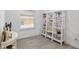 Well-lit home office with a large window and custom shelving for storage and display of decor at 1119 Se 42Nd Rd, Ocala, FL 34480