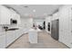 Bright kitchen with white cabinetry, stainless steel appliances, and an eat-in island at 1119 Se 42Nd Rd, Ocala, FL 34480