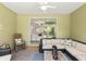 Enclosed patio with wicker furniture and a ceiling fan, offering indoor/outdoor living at 1119 Se 42Nd Rd, Ocala, FL 34480