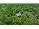 Aerial view of the home nestled among trees at 11311 Ne 40Th Street Rd, Silver Springs, FL 34488