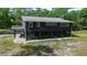 Well-maintained property with a spacious screened-in lower level and beautiful green landscape at 11311 Ne 40Th Street Rd, Silver Springs, FL 34488
