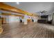Spacious basement with hardwood floors, wooden beam columns, offering ample space for entertainment and recreation at 11311 Ne 40Th Street Rd, Silver Springs, FL 34488