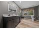 Modern bathroom with a dual sink vanity, deer themed shades, and hardwood floors at 11311 Ne 40Th Street Rd, Silver Springs, FL 34488