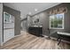 Bathroom with a wood-look floor, a vanity with drawers, gray walls, and a window with a nature-themed curtain at 11311 Ne 40Th Street Rd, Silver Springs, FL 34488