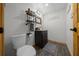 Charming bathroom featuring hardwood floors, a dark wood vanity, and stylish decor at 11311 Ne 40Th Street Rd, Silver Springs, FL 34488