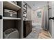 Bathroom featuring tiled shower over tub, modern vanity, and open shelving for storage and organization at 11311 Ne 40Th Street Rd, Silver Springs, FL 34488