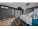 Spacious bedroom with hardwood floors, French doors, and a wall-mounted television at 11311 Ne 40Th Street Rd, Silver Springs, FL 34488