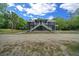 Inviting two-story home with a covered deck, staircase and a well-maintained yard at 11311 Ne 40Th Street Rd, Silver Springs, FL 34488