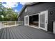 Exterior view of the back of the house including the deck, gray siding, and double French doors at 11311 Ne 40Th Street Rd, Silver Springs, FL 34488