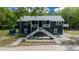 Inviting exterior of a two-story home featuring a staircase and a cozy balcony at 11311 Ne 40Th Street Rd, Silver Springs, FL 34488