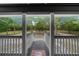 View from front porch looking out onto a large lawn with mature shade trees at 11311 Ne 40Th Street Rd, Silver Springs, FL 34488