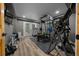 Basement gym equipped with exercise equipment, hardwood floors, and access to the outside at 11311 Ne 40Th Street Rd, Silver Springs, FL 34488