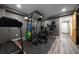 Basement gym featuring exercise equipment, hardwood floors, and gray walls at 11311 Ne 40Th Street Rd, Silver Springs, FL 34488