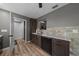 The updated kitchen features modern appliances and sleek cabinetry and stone backsplash at 11311 Ne 40Th Street Rd, Silver Springs, FL 34488
