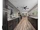Modern kitchen has sleek dark cabinetry, stainless steel appliances, and stone accent wall at 11311 Ne 40Th Street Rd, Silver Springs, FL 34488