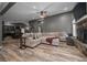 Open-concept living room with a large sectional sofa, fireplace, and modern flooring at 11311 Ne 40Th Street Rd, Silver Springs, FL 34488