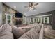 Inviting living room featuring a stone fireplace, a ceiling fan and plenty of natural light at 11311 Ne 40Th Street Rd, Silver Springs, FL 34488
