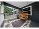 Cozy porch with wooden swing and themed rug creates a welcoming outdoor retreat at 11311 Ne 40Th Street Rd, Silver Springs, FL 34488