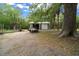 Exterior shot of a large shed with an open door and a trailer parked outside at 11311 Ne 40Th Street Rd, Silver Springs, FL 34488