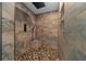 Luxurious walk-in shower with rainfall shower head, stone tile, and a built-in bench at 11311 Ne 40Th Street Rd, Silver Springs, FL 34488