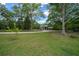 Expansive grassy lot with scattered trees and view of the home in the background at 11311 Ne 40Th Street Rd, Silver Springs, FL 34488