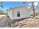 Backyard features a white exterior, window, and fresh dirt ready for landscaping at 11415 Nw 15Th St, Ocala, FL 34482
